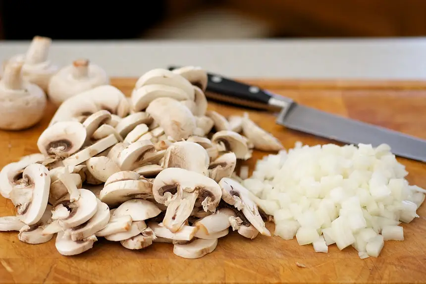 Chop up the onions and slice up the mushrooms.