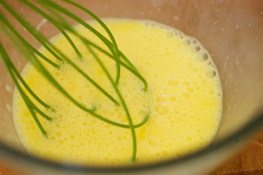 Beat eggs in medium-sized bowl.  