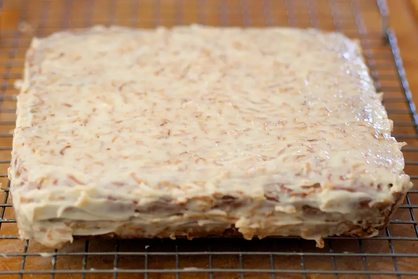 Spread icing evenly over cake,