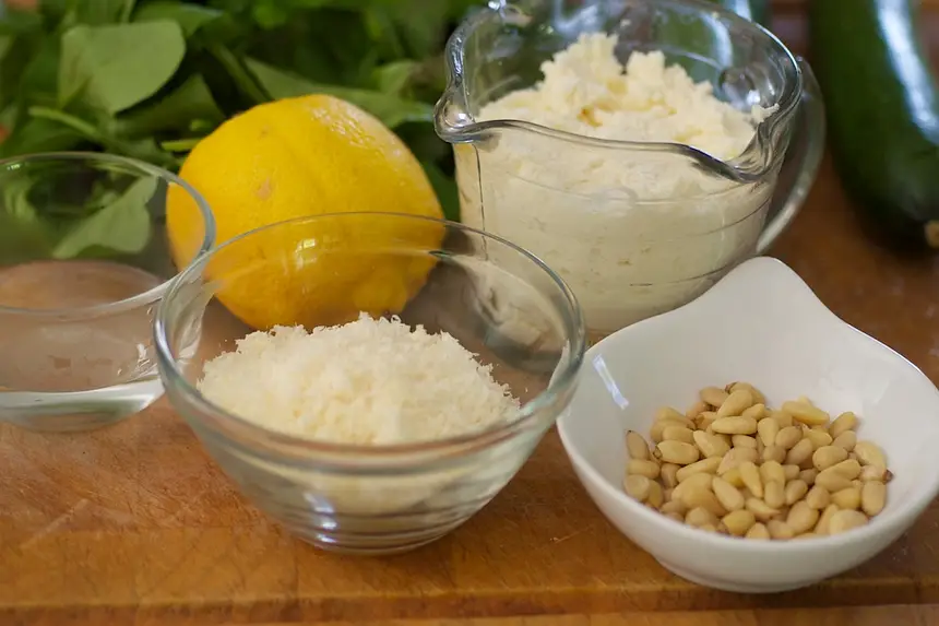 Next you need ricotta, parmesan cheese, lemon, a bit water and pine nuts.
