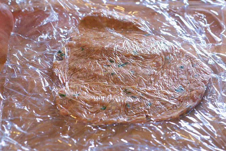 Flatten <a href="/how-to/guide-for-cooking-pork-safe-internal-temperatures" title="Guide for cooking Pork - Safe Internal Temperatures">pork</a> sausage mixture