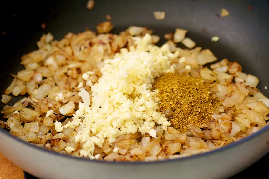 Stir in garlic, ginger and all the spices,