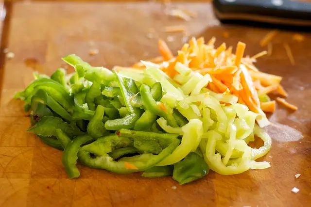 Prepare the carrot and peppers.