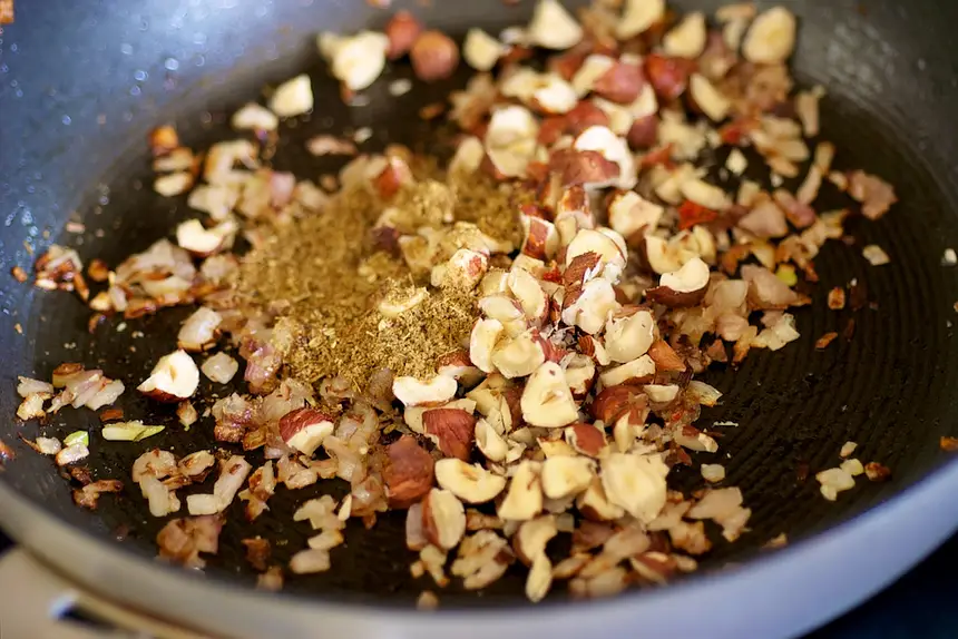 Add the cumin and hazelnuts.