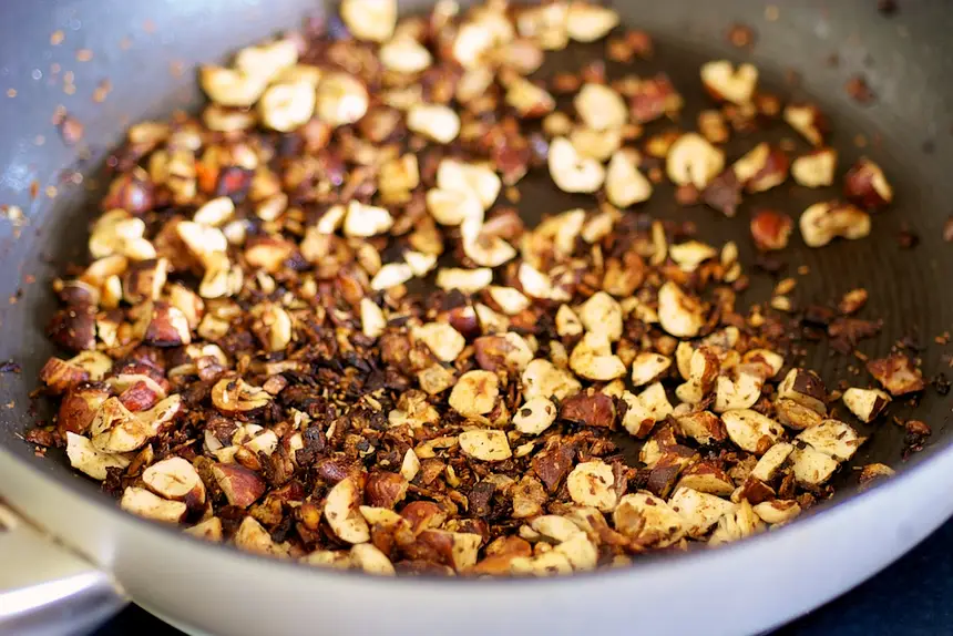 Toast the nuts for about 3 minutes, until lightly browned.