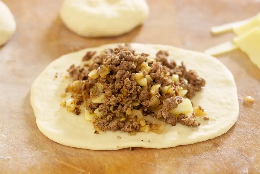 spoon about ¾ cup of the beef and cabbage filling over the cheese