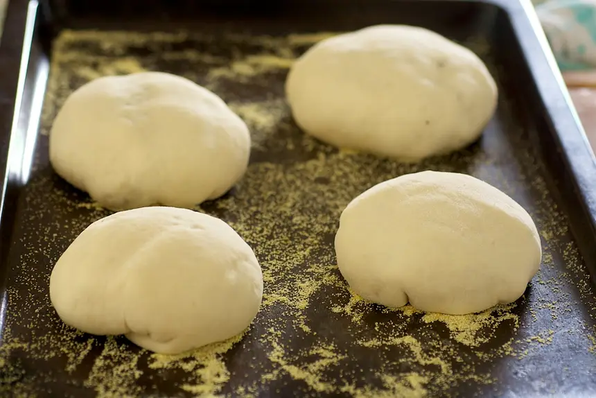 Transfer the bun, seamed side down to the baking sheet.