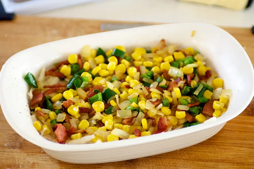 Spread potatoes in ungreased <a href="/how-to/baking-pan-and-dish-volume-guide" title="Baking Pan and Dish Volume Guide">baking dish</a> ,