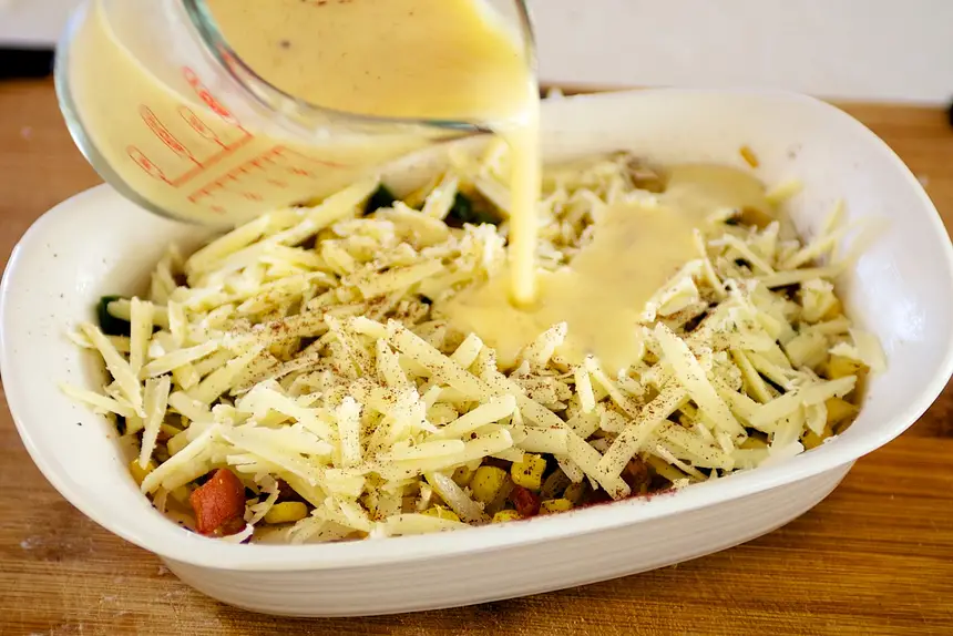 Mix remaining ingredients. Pour over cheese.  