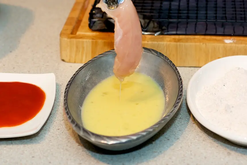 Dip the chicken into the egg mixture.