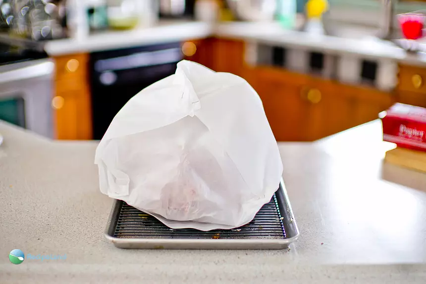Turkey wrapped in parchment paper, ready for the oven