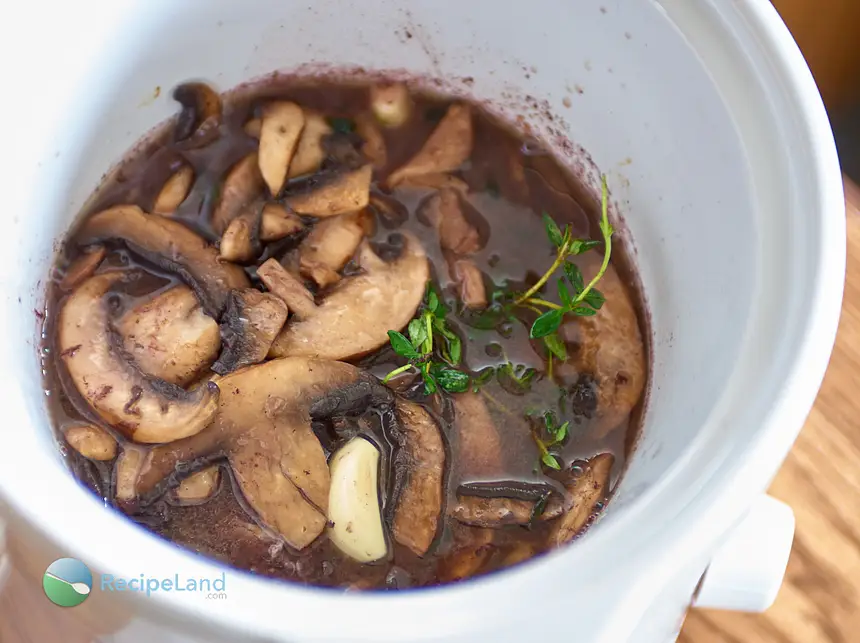 Add the mushrooms to the slow cooker, cover and let simmer.