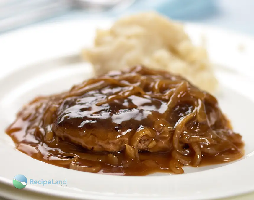 Easy Salisbury steak with onion <a href="/how-to/gravy-survival-guide" title="Gravy Survival Guide">gravy</a> served with potatoes