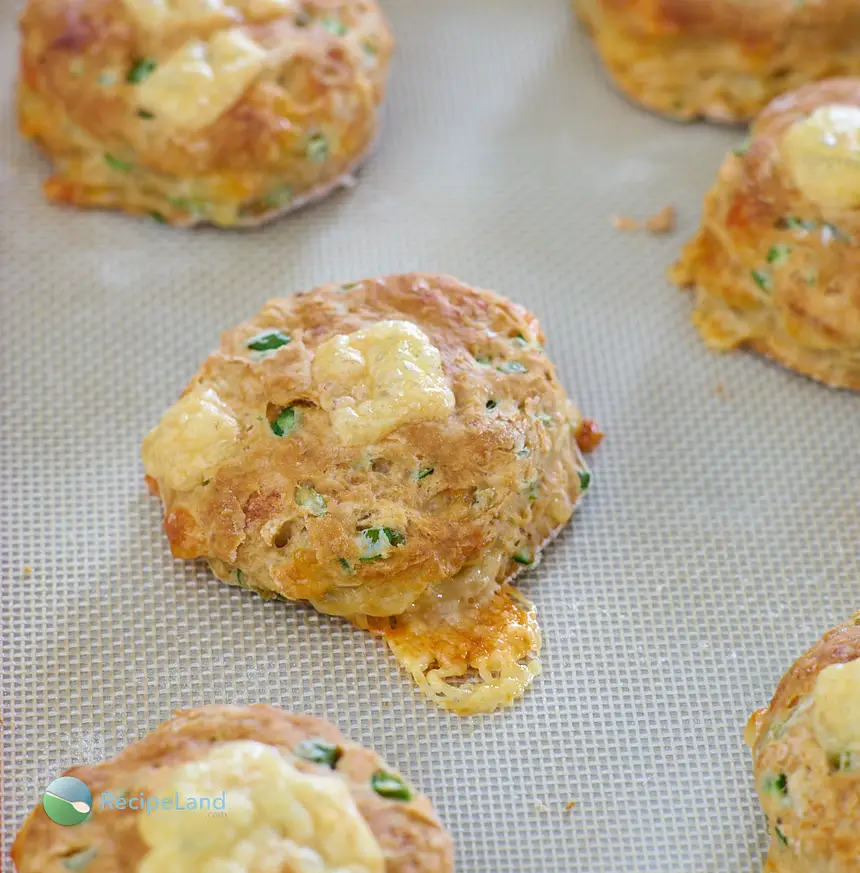 Turn garlic scapes into fluffy, cheesy buttermilk biscuits. The garlic scapes add a fresh mild hint of garlic to the savory biscuits which is perfectly complimentary.