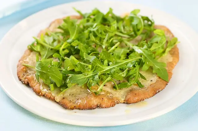 Cheesy & Garlicky White Pizza topped with Fresh Arugula 