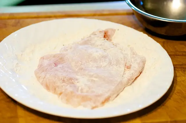 Dredge the breast in the seasoned flour