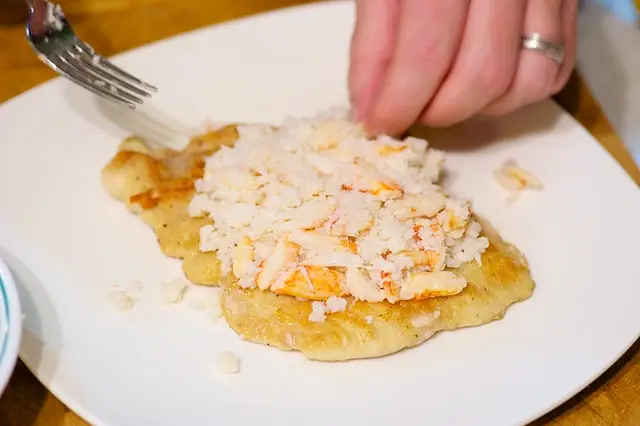 Plating the chicken, top with the crab meat
