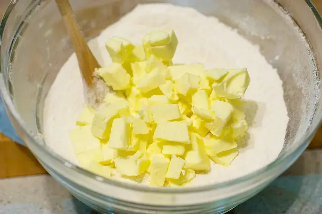 Cut up the butter and add to the flour