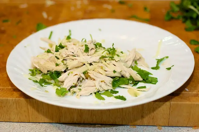 Mix ½ the cheese and cilantro with the shredded chicken