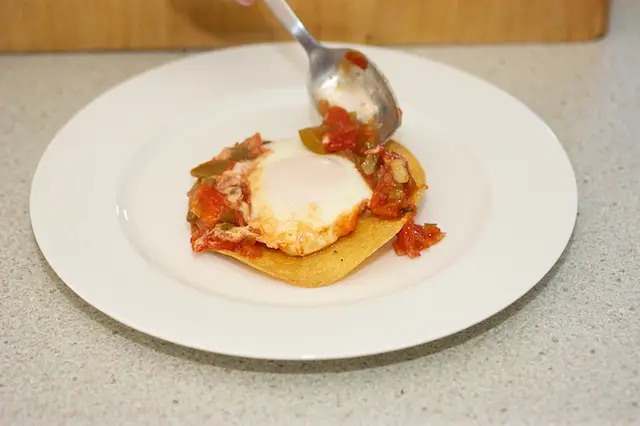 Spoon the salsa around the egg