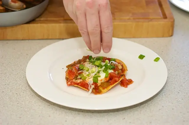 Top with some of the green onions