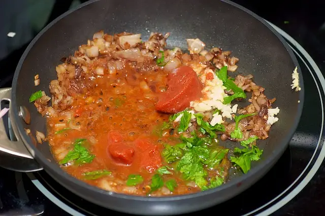 Add the tomato paste, garlic and parsley