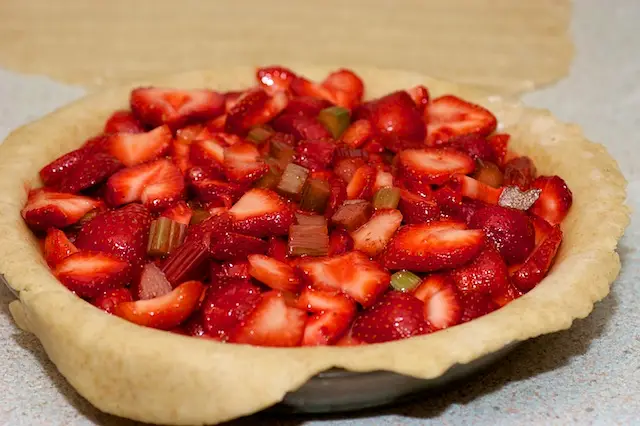 Scrape the filling and any accumulated juices into the crust.