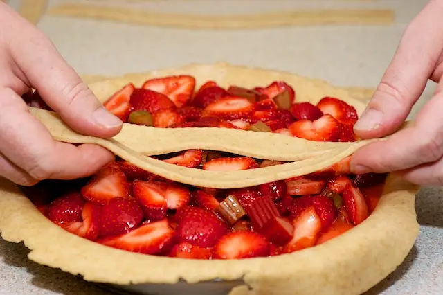 Start laying the strips over the filling...