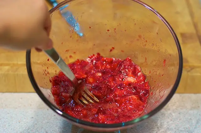 Mash the strawberries with a fork in a large bowl...