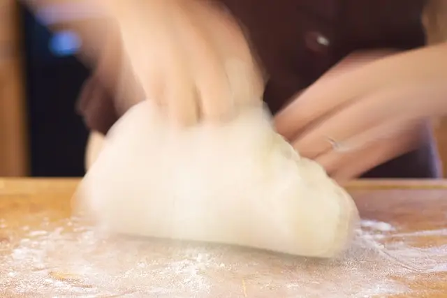 Continue to work in flour until dough is stiff enough to knead...