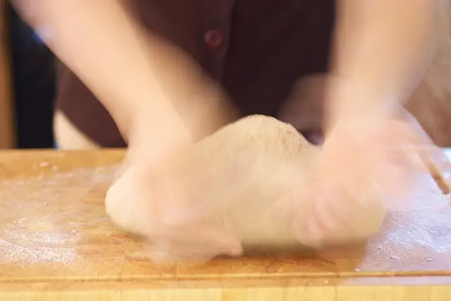 Turn the dough over and keep kneading...