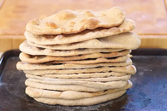 Keep repeating the same steps until all the small balls turn into these lovely naan breads...