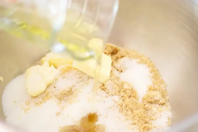 Add butter, oil and sugar in a large mixing bowl with an electric mixer...