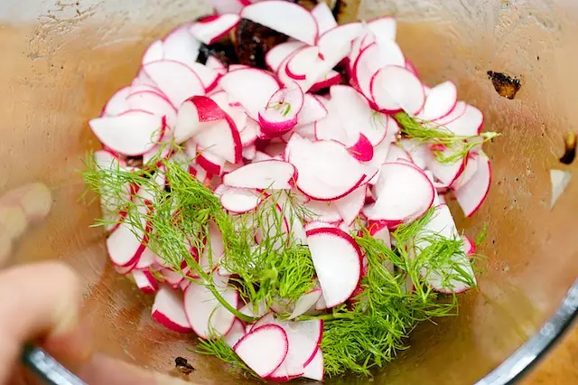 add the sliced radishes and chopped fennel fronds...