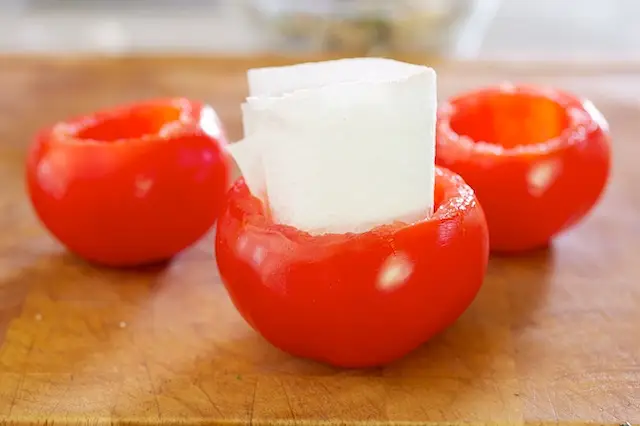 Thoroughly dry the inside of the tomato shells.