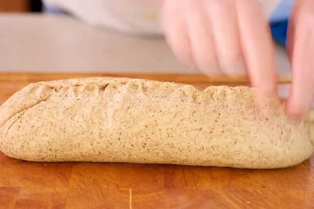 Turn the dough seam side up and pinch it closed.