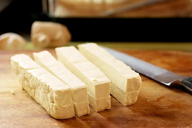 Stack the two halves, slice into 4 equal portions lengthwise as picture shows.