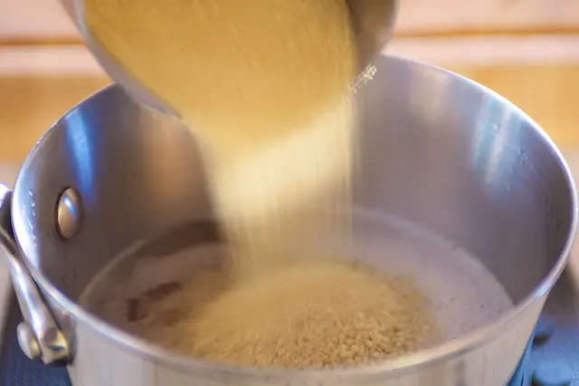 Add the couscous into the boiling vegetable stock.