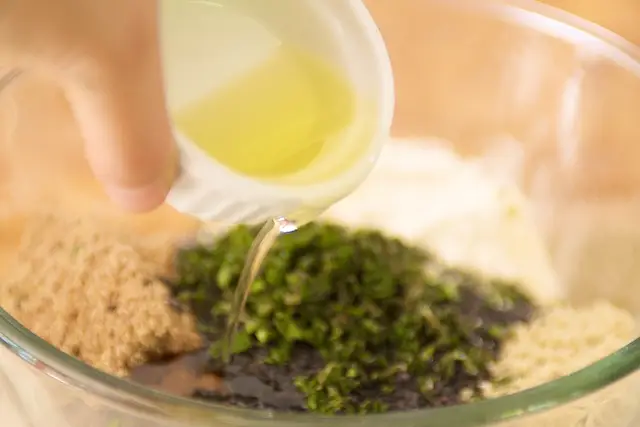 Pour the oil into the mixture.
