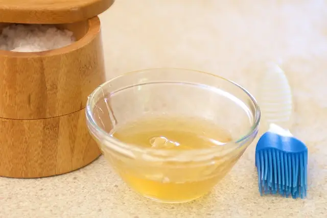 While the crackers are baking, mix together the honey and water to make the glaze.