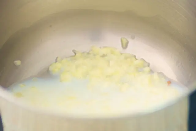 Poach the garlic in some milk