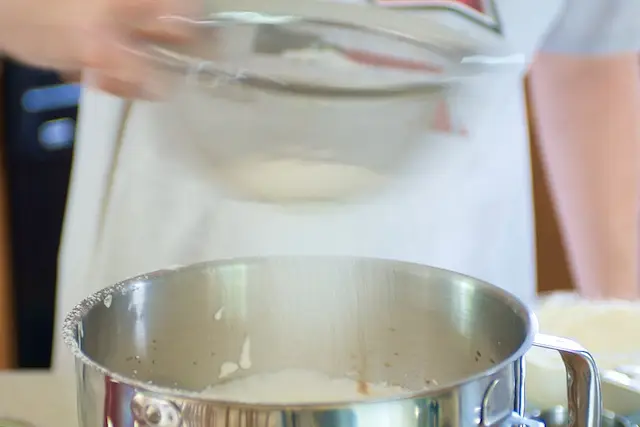 Add ¼ flour mixture at a time, folding in gently with rubber spatula. 