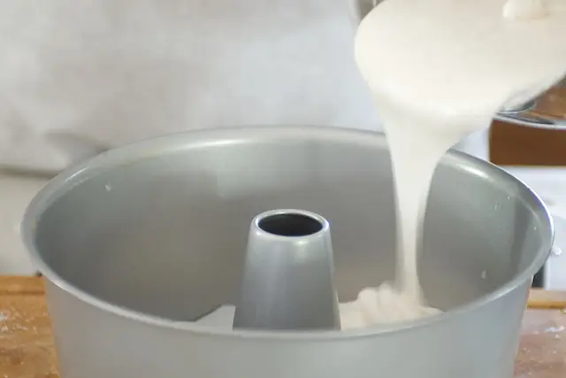 Gently pour the smooth mixture into the prepared angel food cake pan.