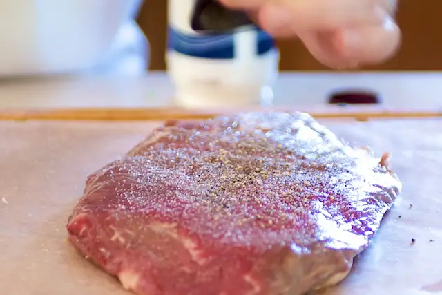 Season the flank steak with salt and pepper
