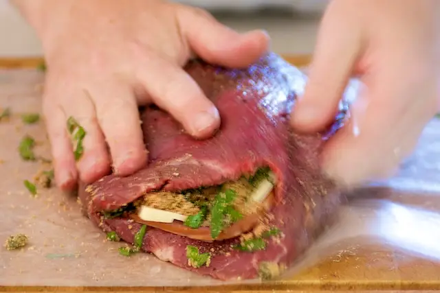 Fold in the stuffing with the other half of the flank steak