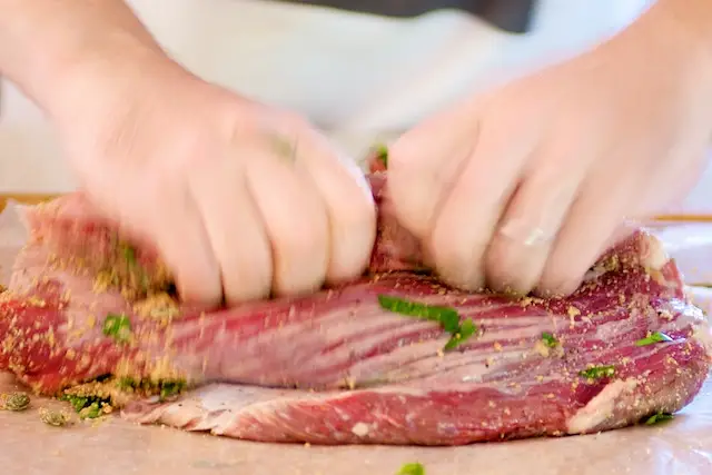 Tightly roll the stuffed flank steak lengthwise