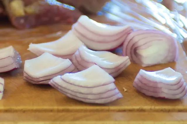 Peel and cut the onion into quarters.