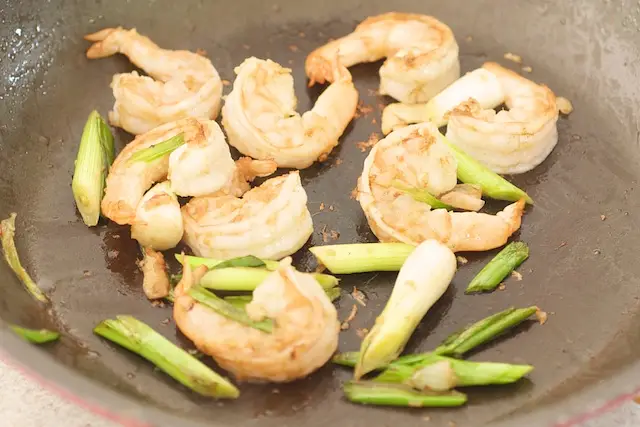 Add another tablespoon of oil to the pan. Add the scallions and stir fry for 30 seconds.