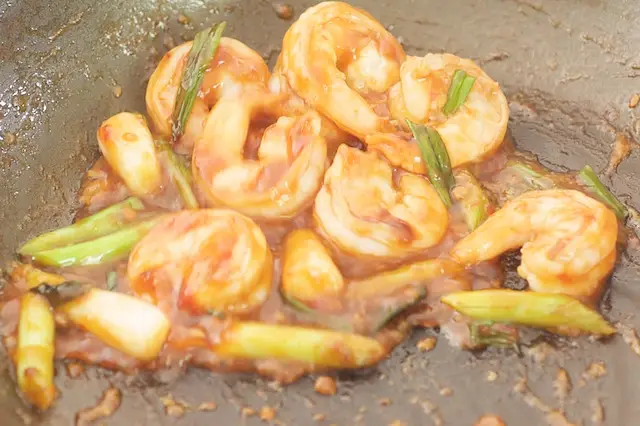 Then add the sauce and allow to poach for about two minutes until the sauce has thickened is more sticky and coats the shrimp.