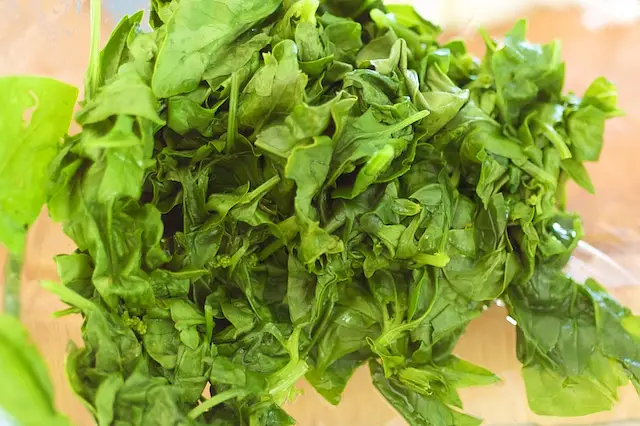 Meanwhile, add the spinach and water in a large skillet pan, cook the spinach until wilted, 2 to 3 minutes.
